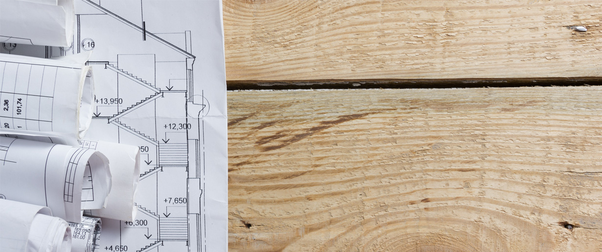 House plans sitting on a wood surface