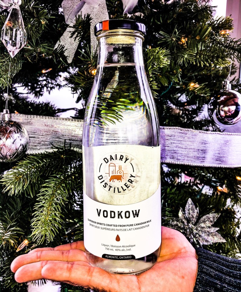 Handholding a bottle of Vodkow from Dairy Distillery