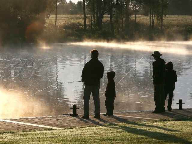 Family fishing along a river