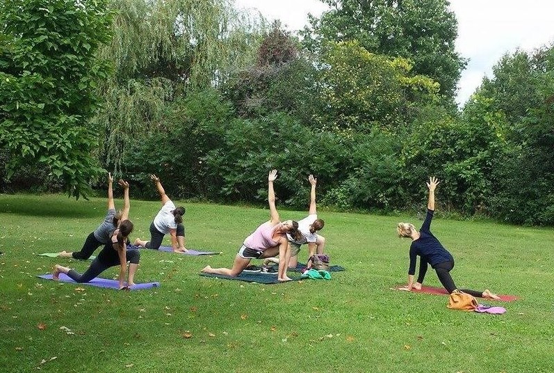 A group of women doing yoga outdoor