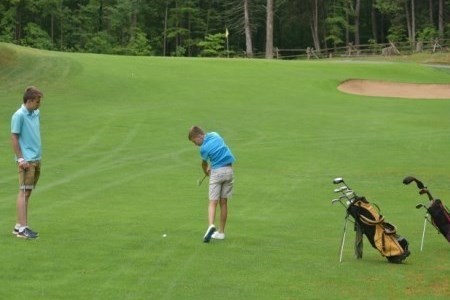 two boys playing golf